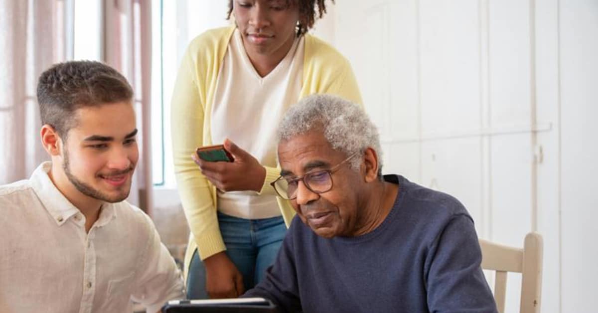 elderly man being helped by caregivers