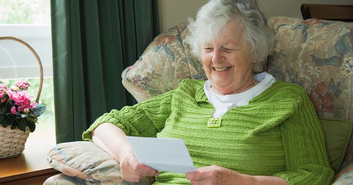 senior lady smiling while reading