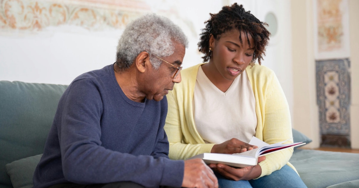 father and daughter looking at a book together