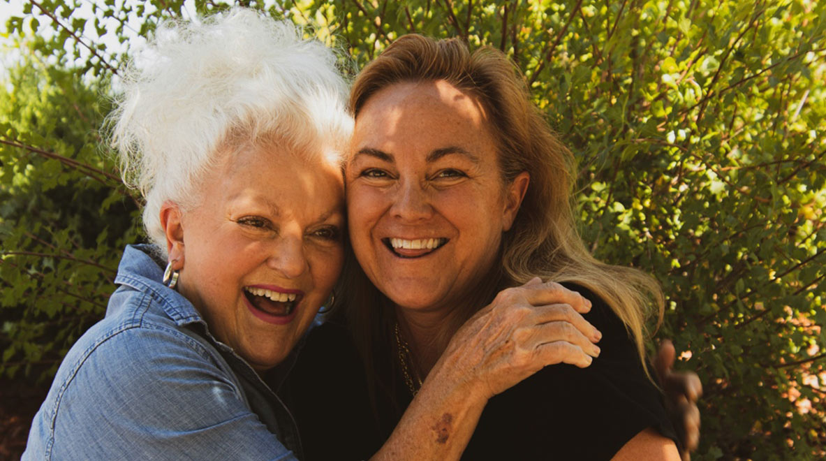 happy senior posing for photo with daughter